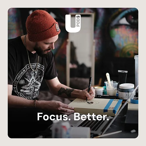 A man using his UPods to focus on work.